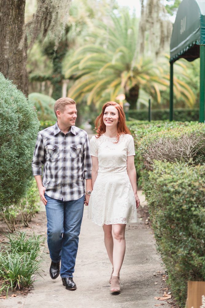 Engaged couple walking along the sidewalk during their beautiful photo shoot in Winter Park with one of the best wedding photographers in Orlando