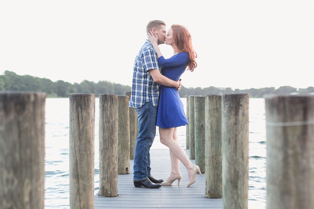 Romantic engagement photography on a pier in Winter Park at sunset captured by top Orlando wedding photographer