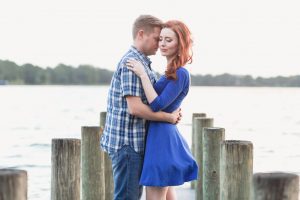 Romantic engagement photography on a pier in Winter Park at sunset captured by top Orlando wedding photographer