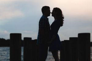 Silhouette of an engaged couple on the dock at Winter Park Rollins College during their engagement photo shoot