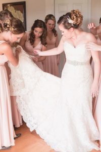 Bride getting ready with her bridesmaids featuring blush dresses for their country wedding day at a barn in Central Florida