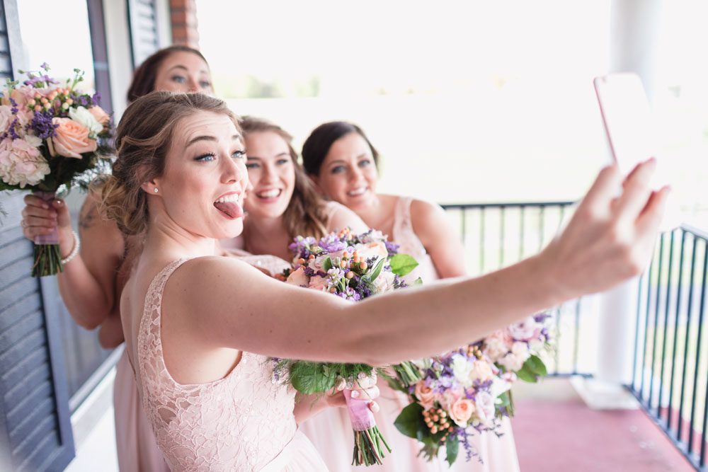 Bridesmaids taking a fun selfie during a country rustic wedding north of Orlando