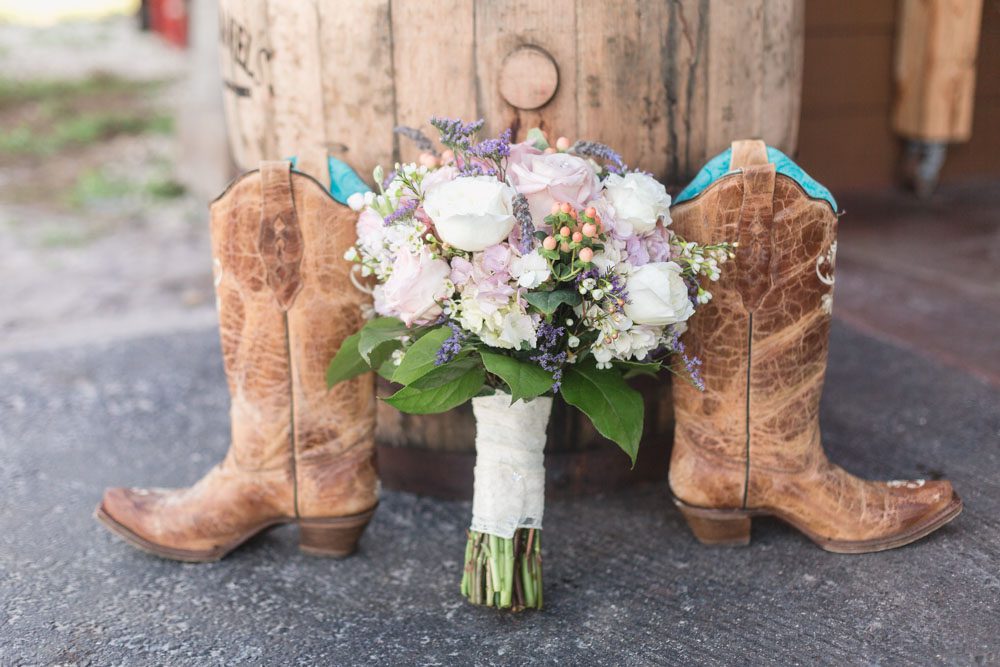 Rustic country wedding cowgirl boots and bouquet featuring burlap and lace for a barn wedding in Orlando, Florida