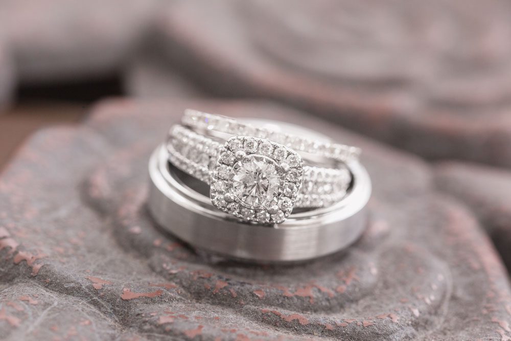 Close up of the wedding rings on a wrought iron table captured by top Orlando wedding photographer and videographer
