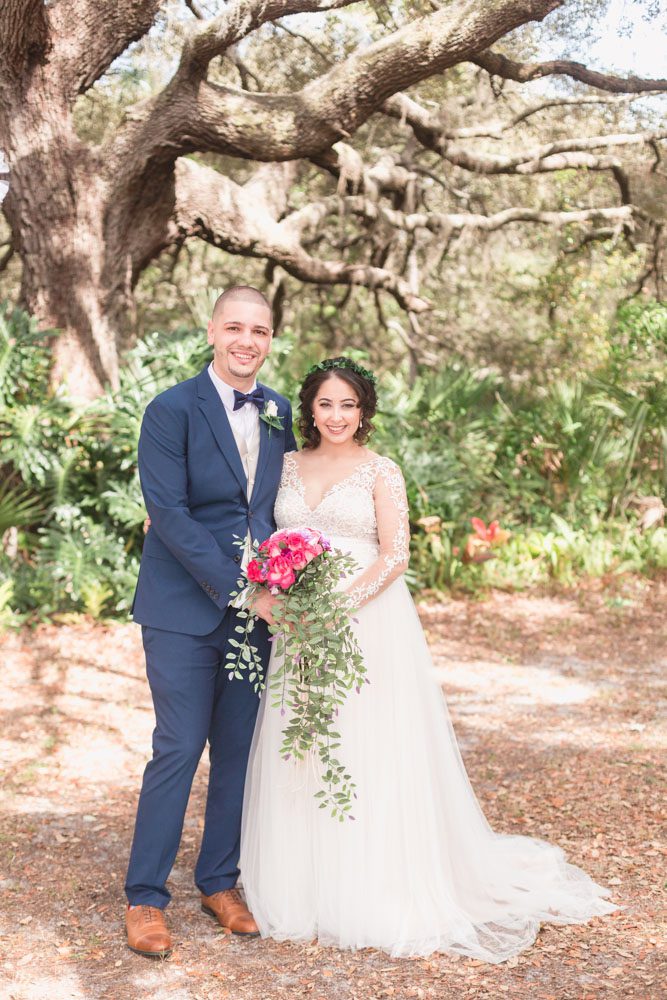 Portrait of the bride and groom under a tree after their outdoor backyard wedding ceremony in Kissimmee, Florida south of Orlando