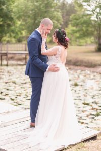 Sweet photo of the newlyweds on a dock during their romantic intimate backyard wedding day in Kissimmee Florida captured by top Orlando wedding photography team