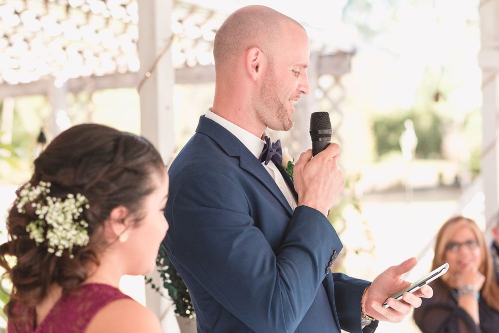 Best man gives a speech during an intimate outdoor wedding reception in Kissimmee, Florida just south of Orlando during a rustic boho chic wedding