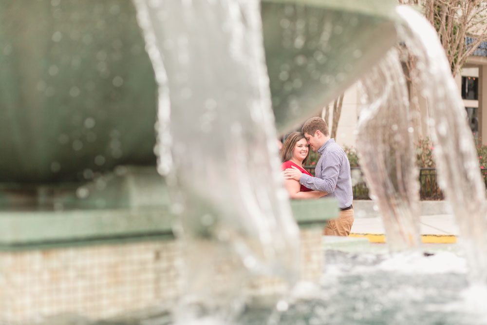 Creative engagement photo taken through a fountain at Baldwin Park by top Orlando wedding and engagement photographer