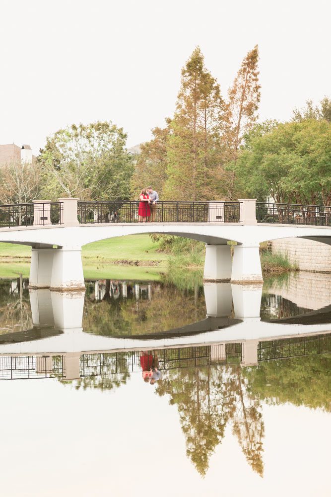 Creative engagement photo taken on a bride in Baldwin Park featuring the reflection of the water captured by top Central Florida photographer
