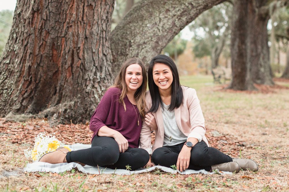 Picnic style same-sex engagement session by the lake in downtown captured by Orlando photographer