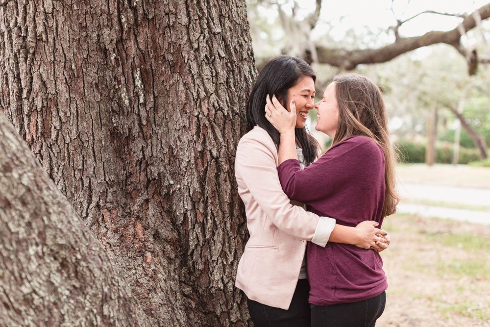Beautiful engagement portrait under the sprawling trees of Lake Lawsona captured by same-sex engagement photographer in Orlando