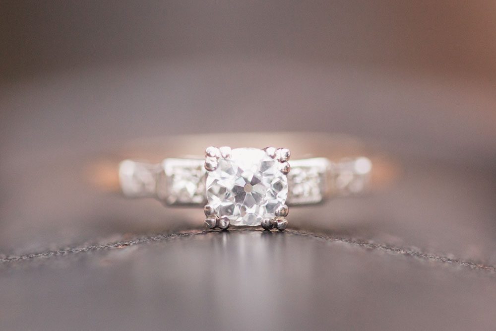 Close up of vintage style engagement ring during an engagement photography session in Orlando, Florida