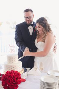 Orlando wedding photographer captures the newlyweds cutting their Disney themed wedding cake