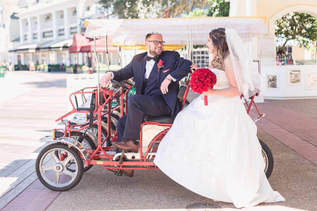 Photo of the bride and groom on a surrey bike at the Boardwalk Inn during their Disney wedding day