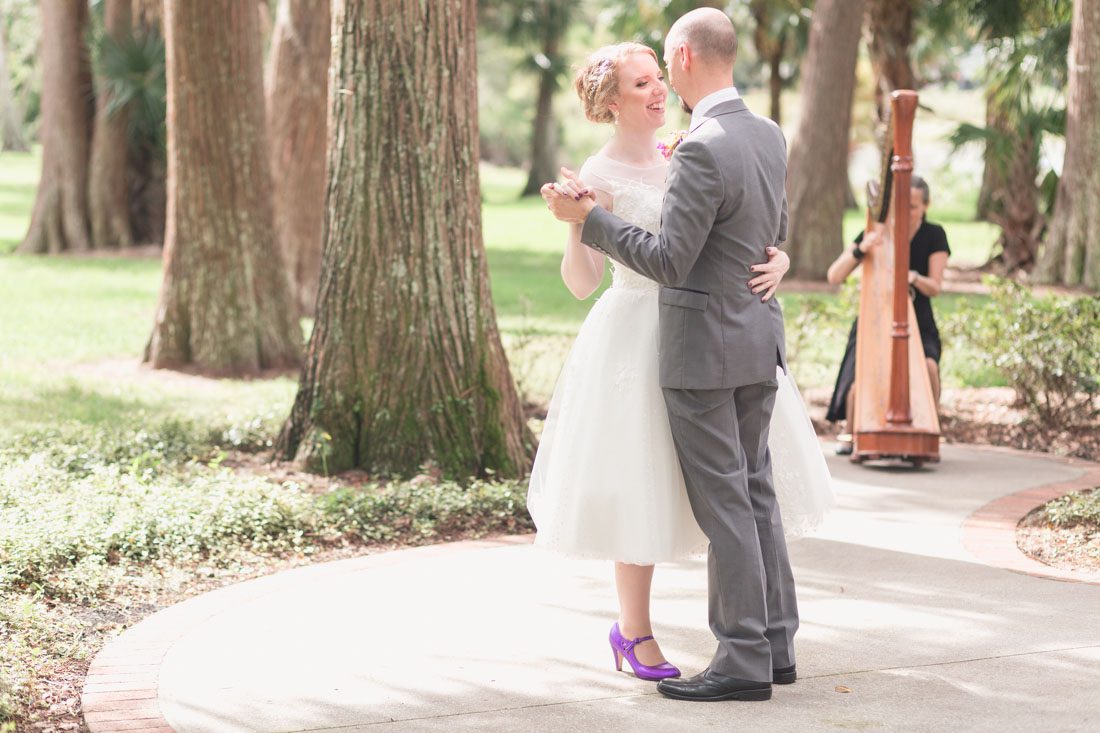 Couple shares their first dance in the park with a harpist after their elopement at Cypress Grove park captured by top Orlando photographer and videographer