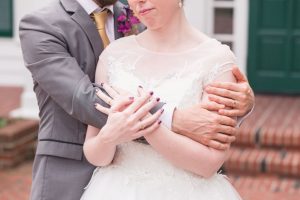 Wedding photographer in Orlando captures a romantic photo of the bride and groom featuring their wedding bands at Cypress Grove Estate House wedding venue in Orlando