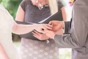 Couple exchanges rings during elopement at Cypress Grove in Orlando captured by top photographer and videographer