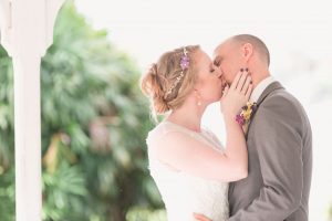 Newlyweds share their first kiss during their ceremony at Cypress Grove by top Orlando wedding photographers