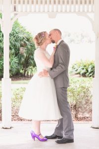 Newlyweds share their first kiss during their ceremony at Cypress Grove by top Orlando wedding photographers
