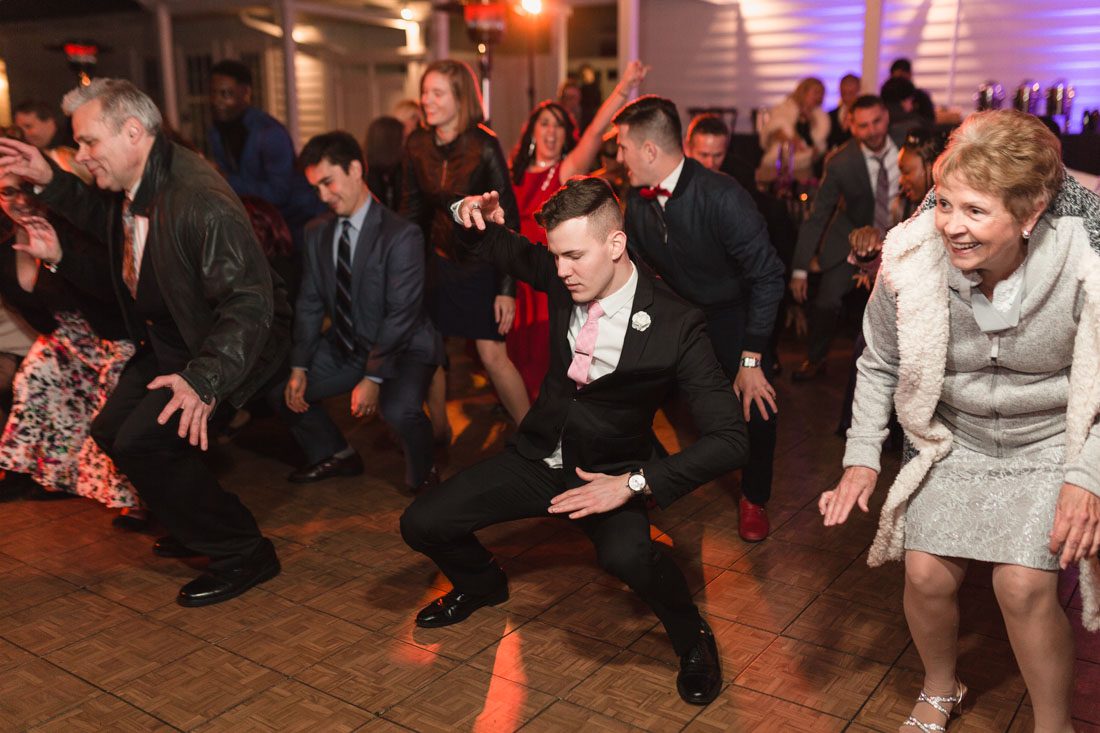 Orlando wedding photographer captures candid photos on the dance floor at a reception for a gay wedding in Orlando at Cypress Grove