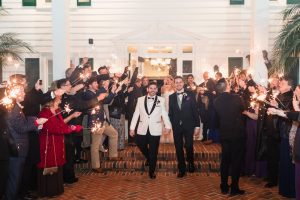 Grooms during their sparkler exit from their gay wedding at the Cypress Grove estate house by top same-sex wedding photographer in Orlando