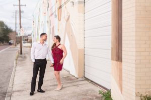 Fun location for an engagement session in downtown Orlando featuring art murals captured by top wedding photographer in Orlando