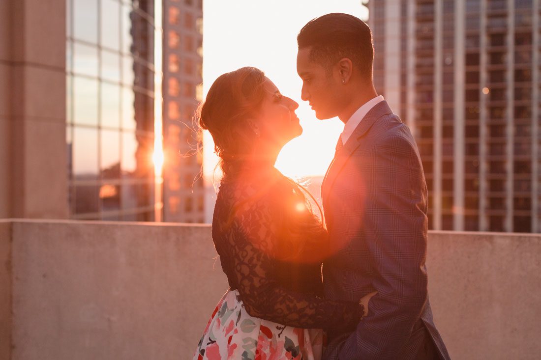 Sunset rooftop location engagement photography at the Balcony in downtown Orlando during a romantic engagement photo shoot
