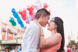 Engagement photography at Disney featuring Mickey Mouse balloons captured by top Orlando engagement and wedding photographer