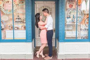 Disney engagement photography in front of the candy shop at Main Street at Magic Kingdom park in Orlando, Florida