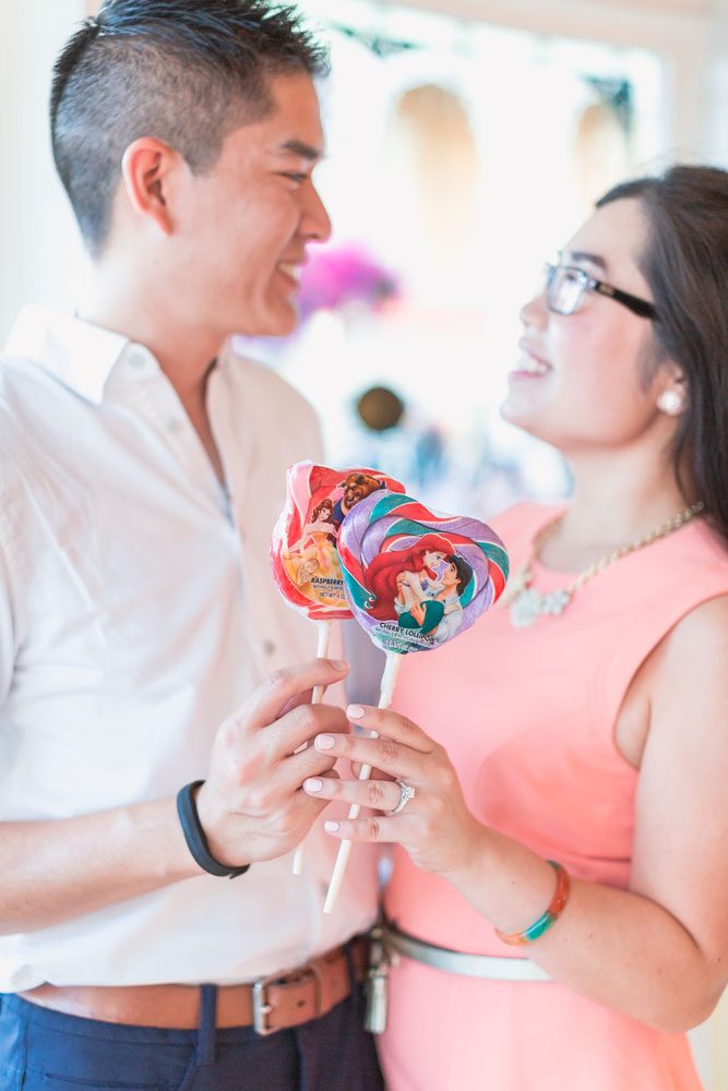 Fun engagement photo taken at Disney World candy shop by top Orlando wedding and engagement photographer