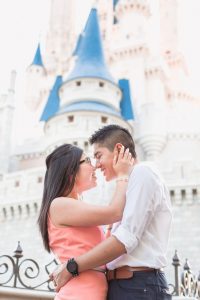 Orlando engagement photographer captures couple in front of Cinderella's castle at Walt Disney World engagement photo shoot