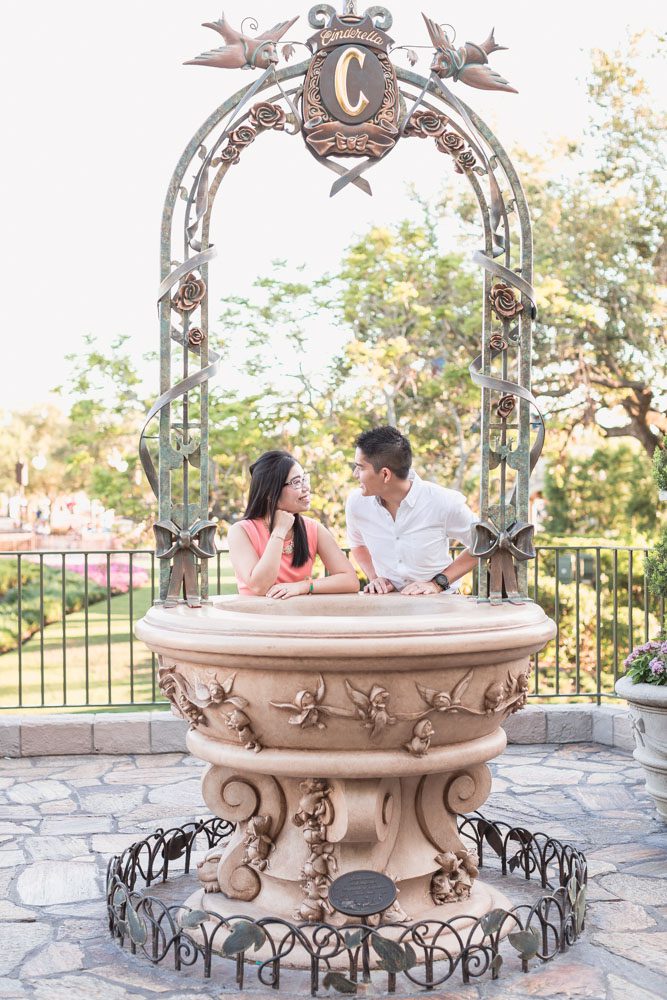 Disney engagement photographer captures photo at Cinderella's wishing well at Magic Kingdom Park in Orlando, Florida