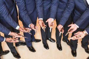 Groomsmen showing off their wedding gifts captured by top Orlando wedding photographer and videographer