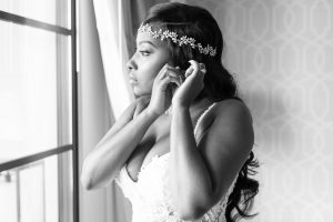 Black and white photo of the bride getting ready for her Disney wedding at the Four Seasons in Orlando