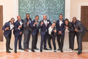 Groom poses for a fun photo with his fraternity brothers at the Four Seasons in Orlando