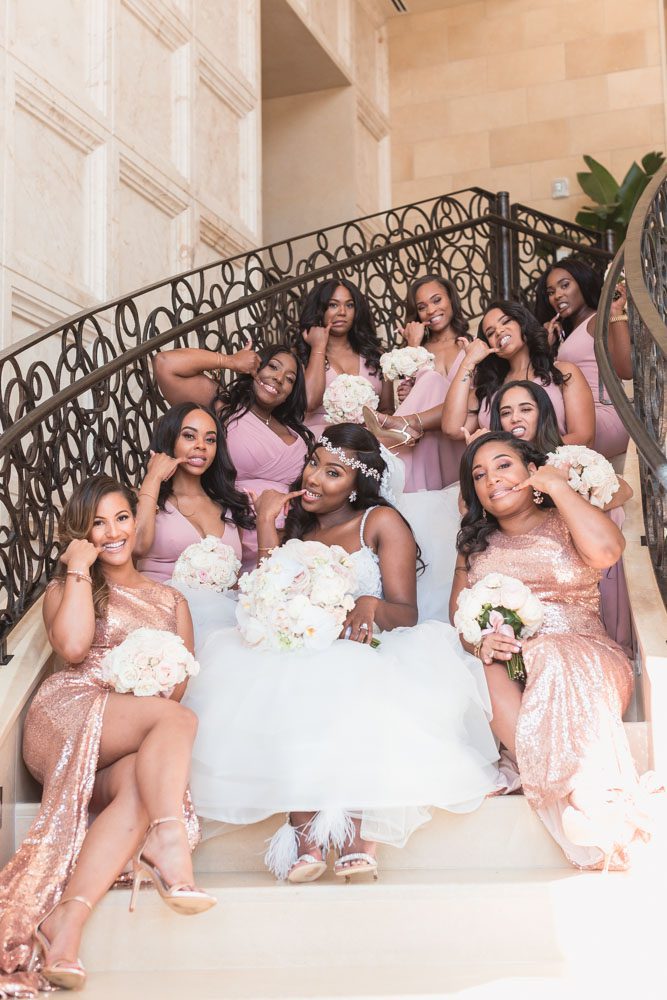 Bridal party portrait on the iconic steps of the Four Seasons in Orlando captured by top wedding photographer in Orlando