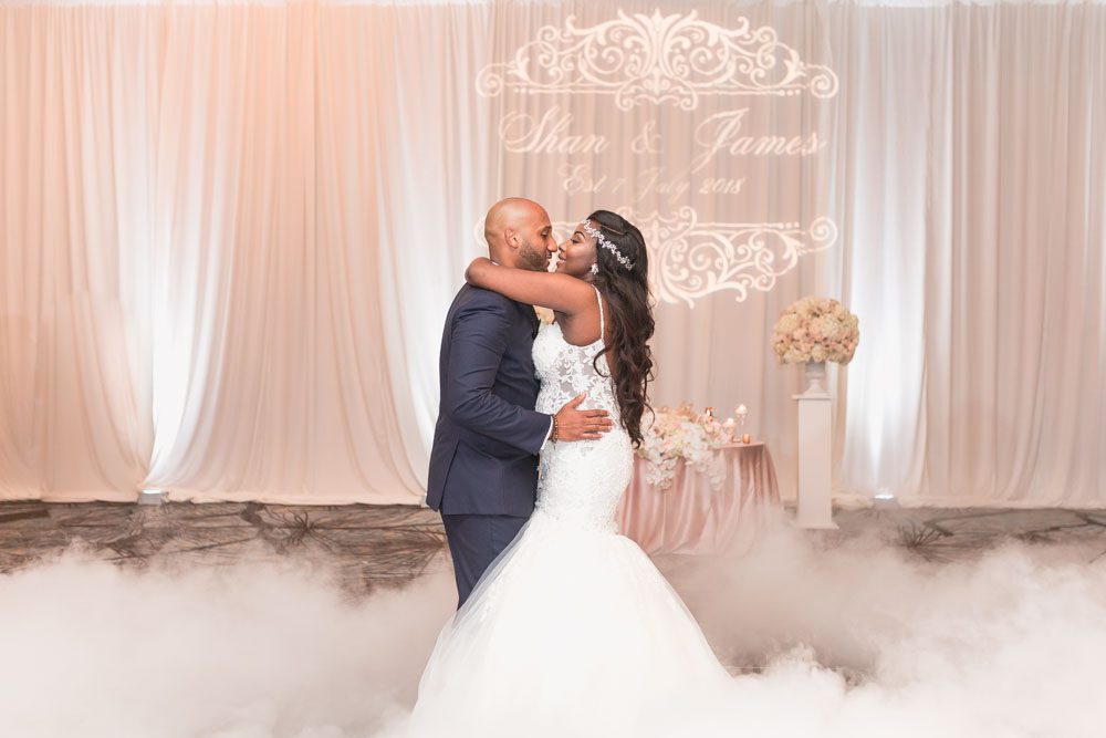 Bride and groom share their first dance on a cloud captured by top Orlando wedding photographer at their Four Seasons reception