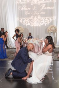 Groom retrieves the garter during his Orlando wedding day at the Four Seasons resort
