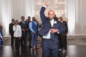 Orlando wedding photography team captures the groom throwing the garter at the Four Seasons