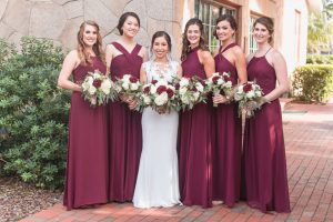 Portrait of the bride and bridesmaids in burgundy red dresses at Estate on the Halifax wedding east of Orlando