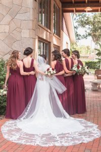 Portrait of the bride and bridesmaids in burgundy red dresses at Estate on the Halifax wedding east of Orlando
