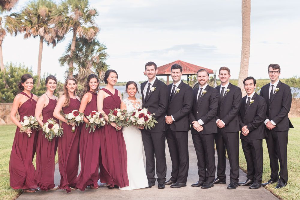 Photo of the wedding party featuring bridesmaids in wine red burgundy dresses captured by Orlando photographer