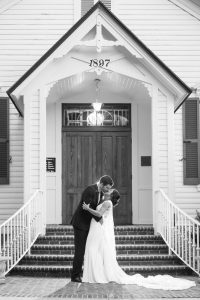 Black and white portrait in front of the chapel at the Estate on the Halifax captured by top Orlando wedding photographer