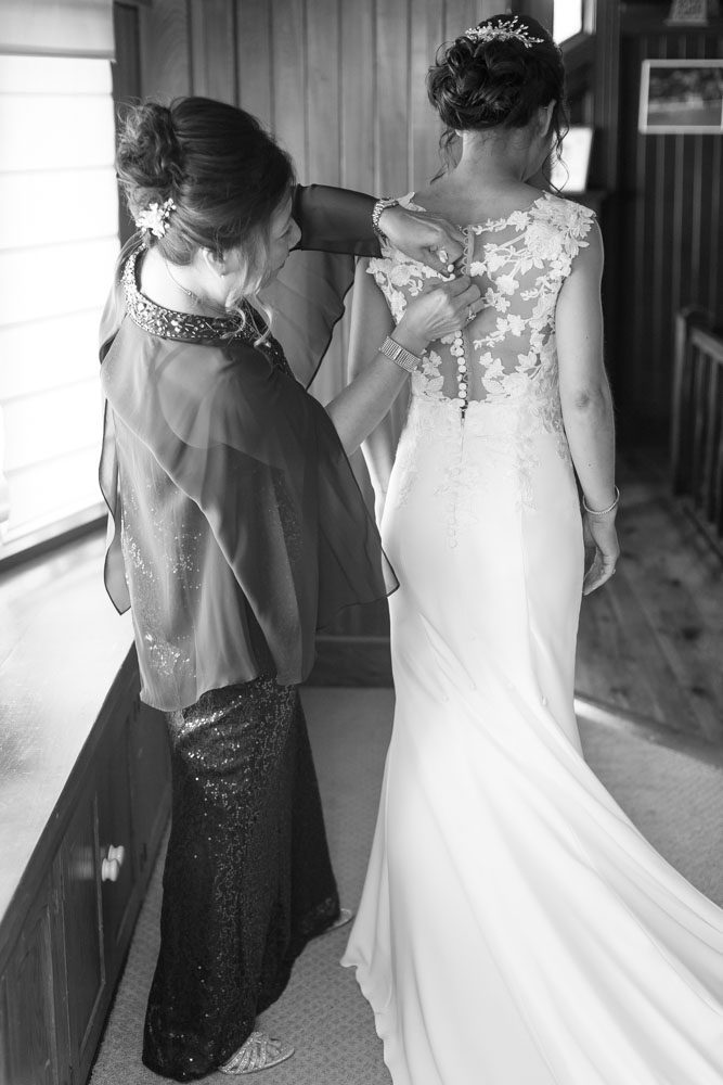 Bride getting ready with her mom during her wedding at the Estate on the Halifax east of Orlando, Florida