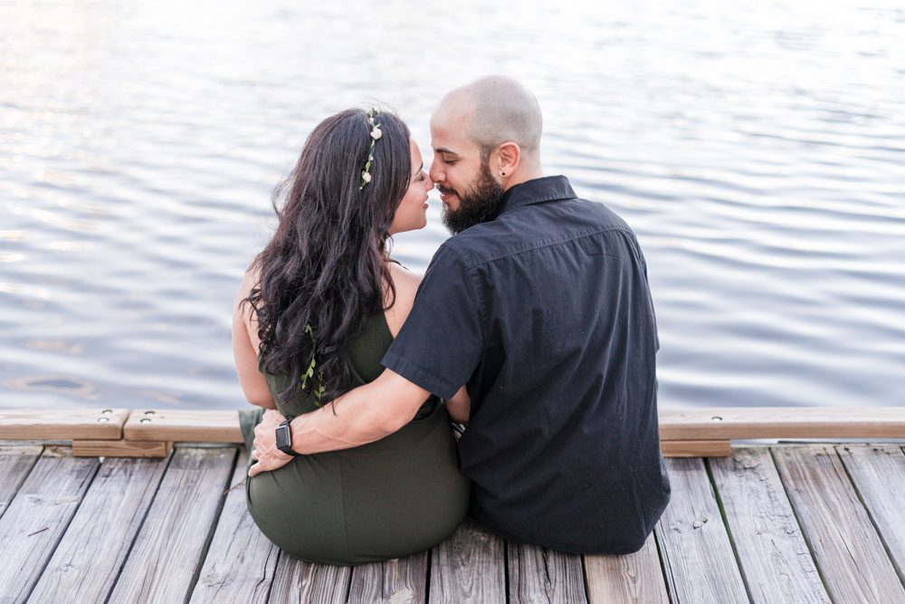 Fun engagement session on the lakefront pier in Celebration dock captured by top Orlando engagement photography team