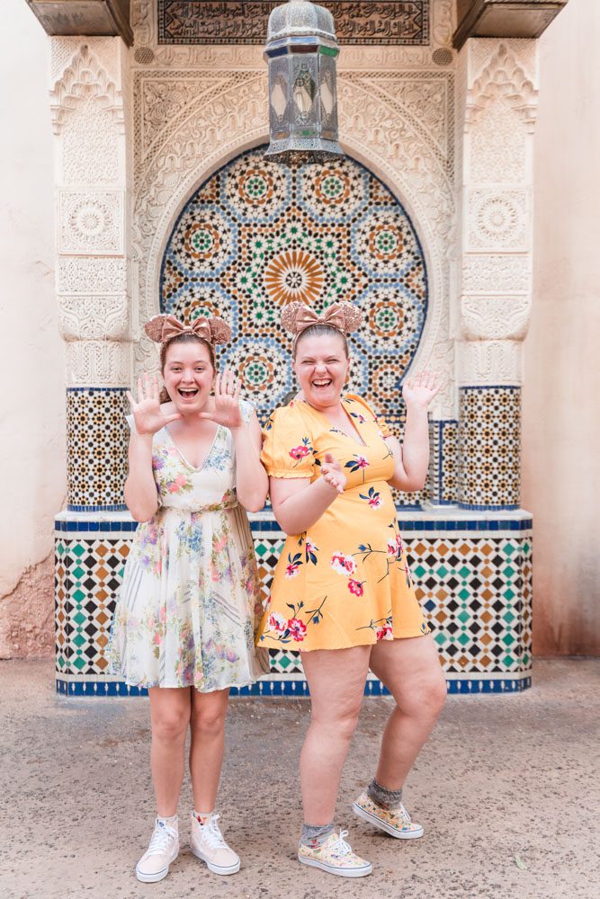 Fun and candid same-sex engagement session at Morocco in Epcot at Disney World captured by top Orlando gay wedding photographer