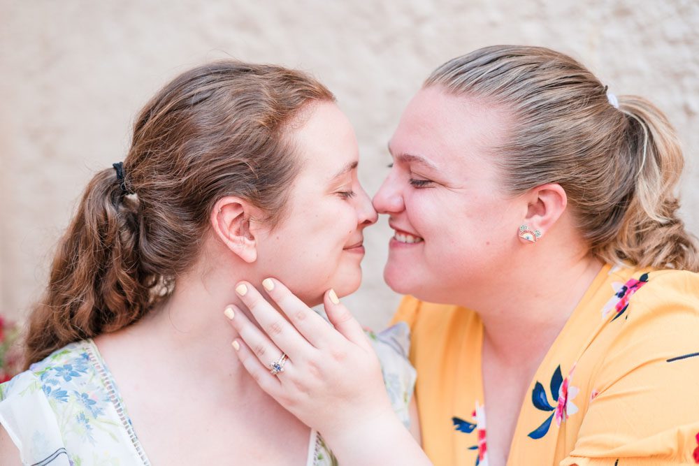 Fun and candid same-sex engagement session at Morocco in Epcot at Disney World captured by top Orlando gay wedding photographer