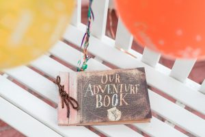 Disney UP movie themed surprise proposal in Orlando, Florida featuring an Adventure Book album