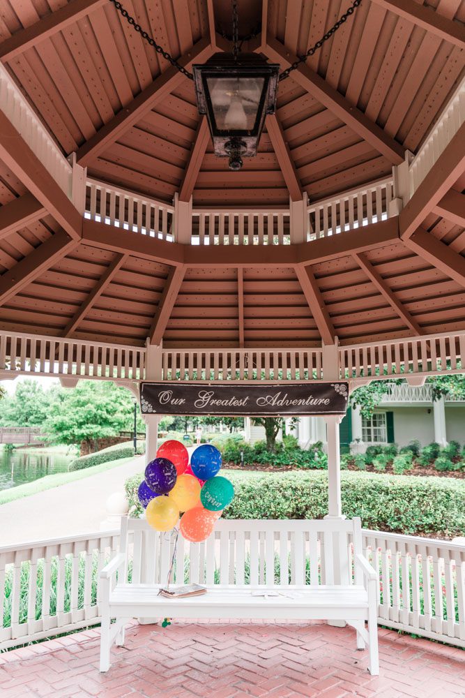 Disney UP movie themed surprise proposal in Orlando, Florida featuring balloons and an Adventure Book album