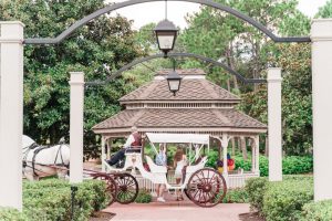Horse carriage ride turns into a surprise proposal captured by top Orlando engagement photographer at Disney